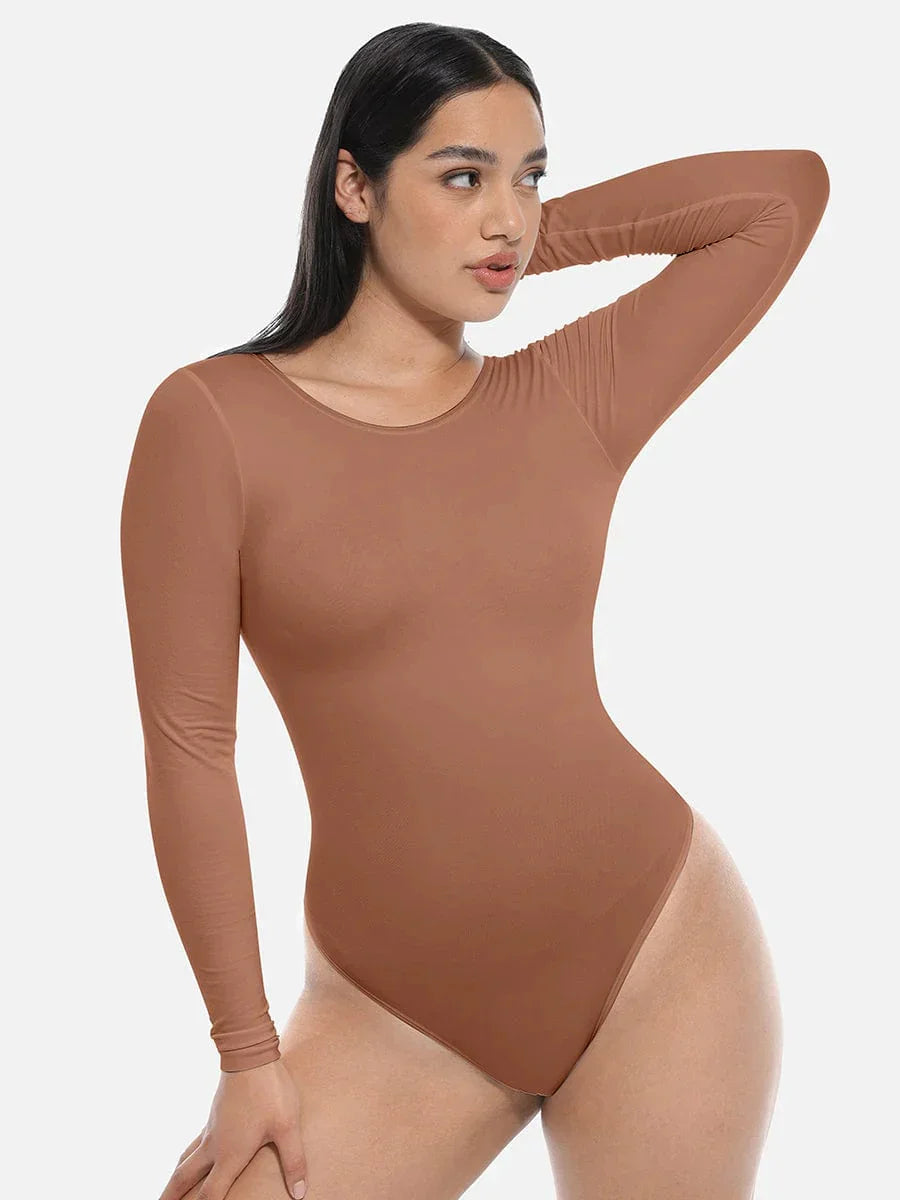Woman wearing seamless long sleeve brown bodysuit shapewear on a white background