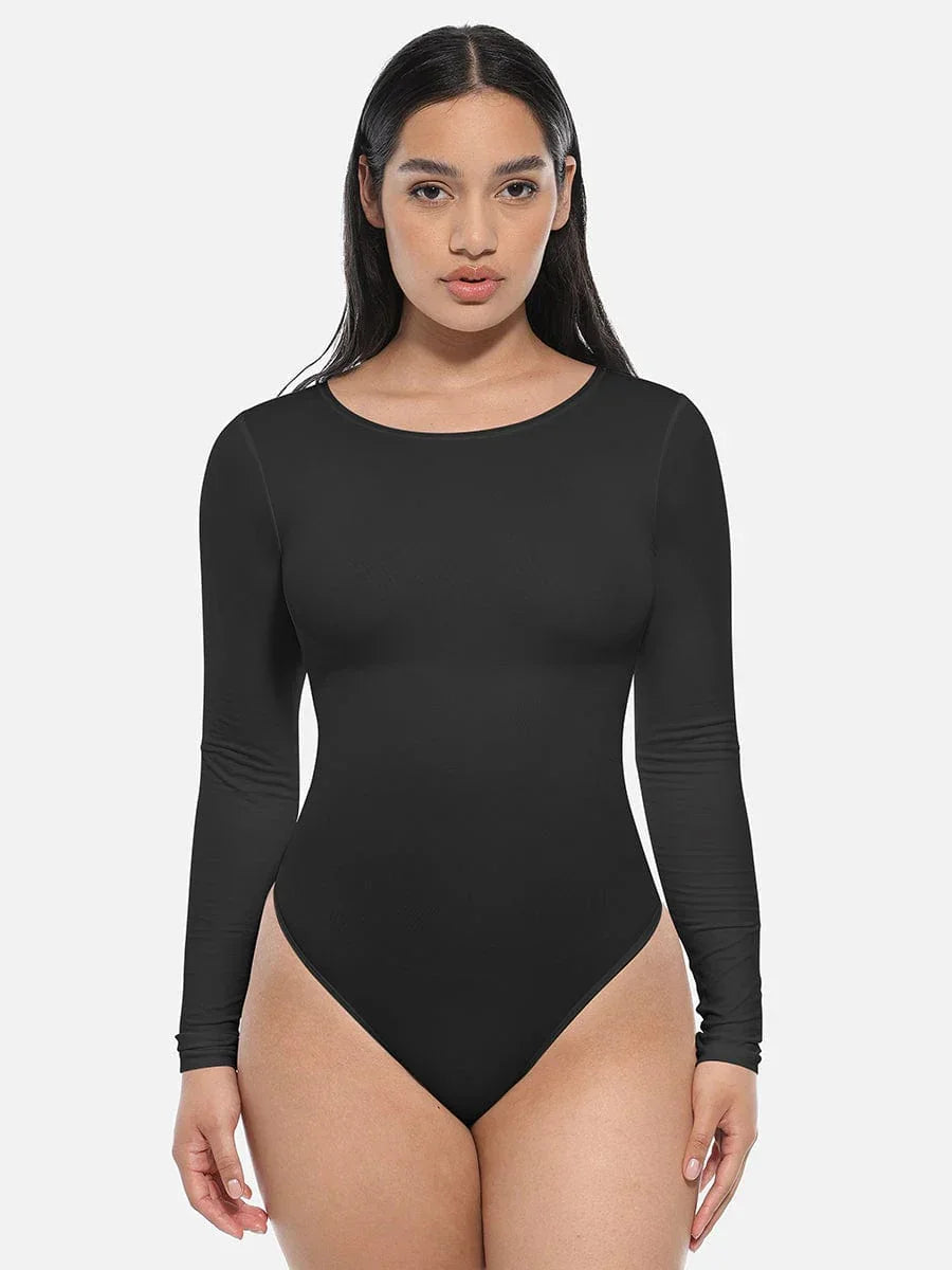 Woman wearing black long sleeve bodysuit shapewear, front view, on white background.