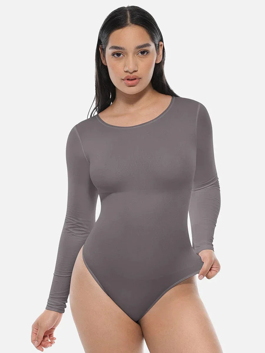 Woman wearing long sleeve seamless grey bodysuit shapewear on white background