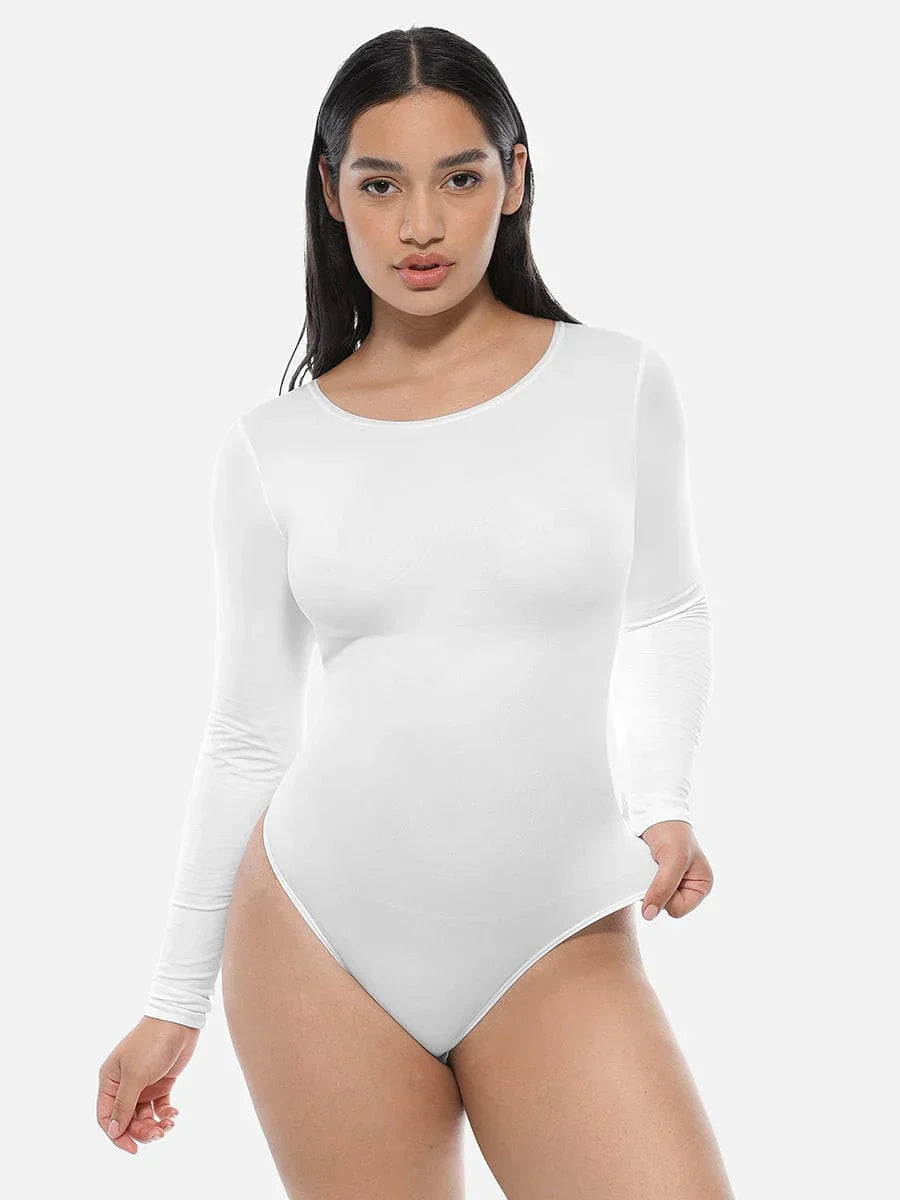 Woman modeling seamless white long sleeve bodysuit shapewear against a plain background
